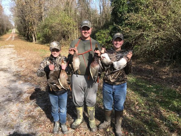 three young duck hunters in southern illinois